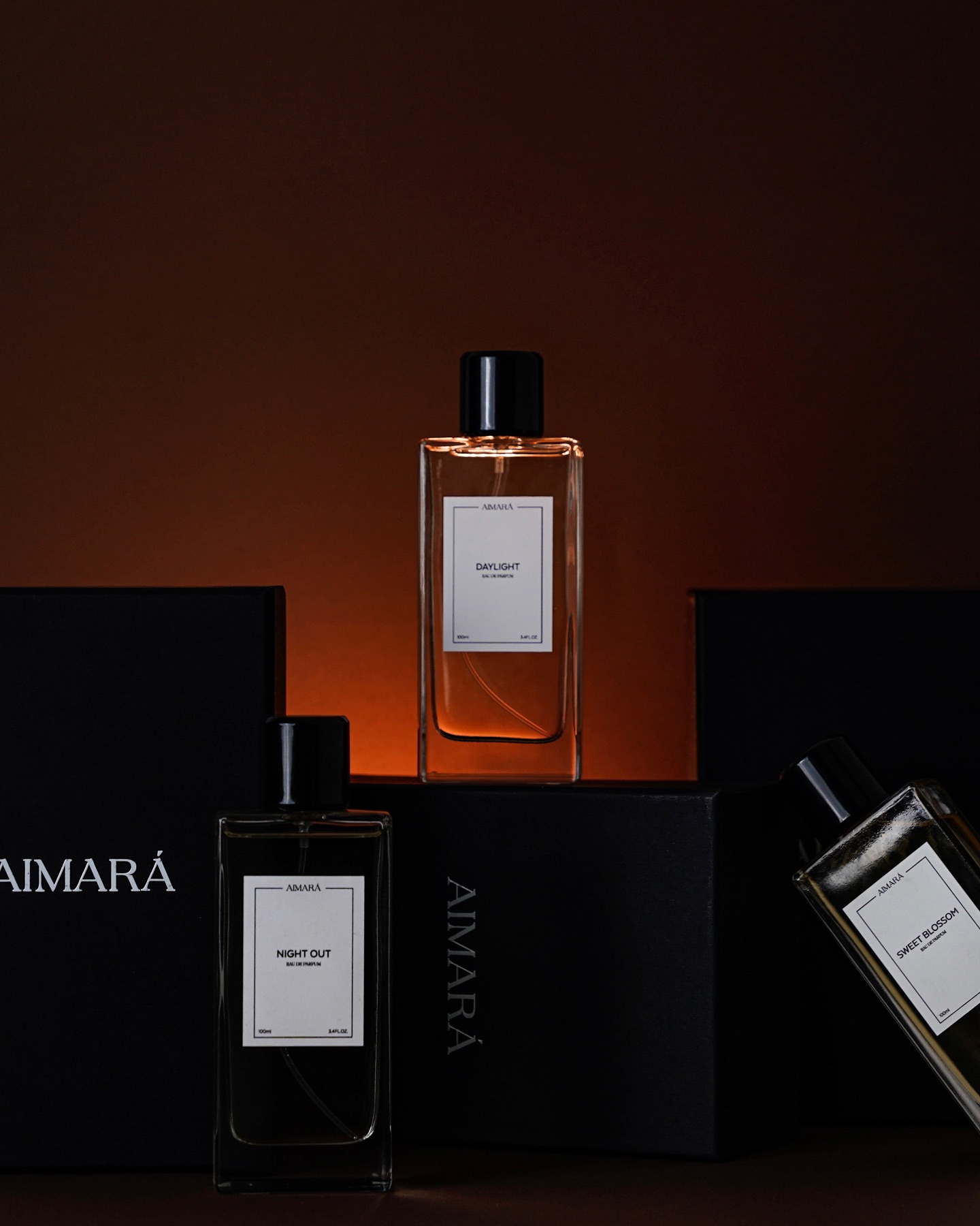 Luxury perfume bottle displayed with branded packaging against a dark background with warm cinematic lighting
