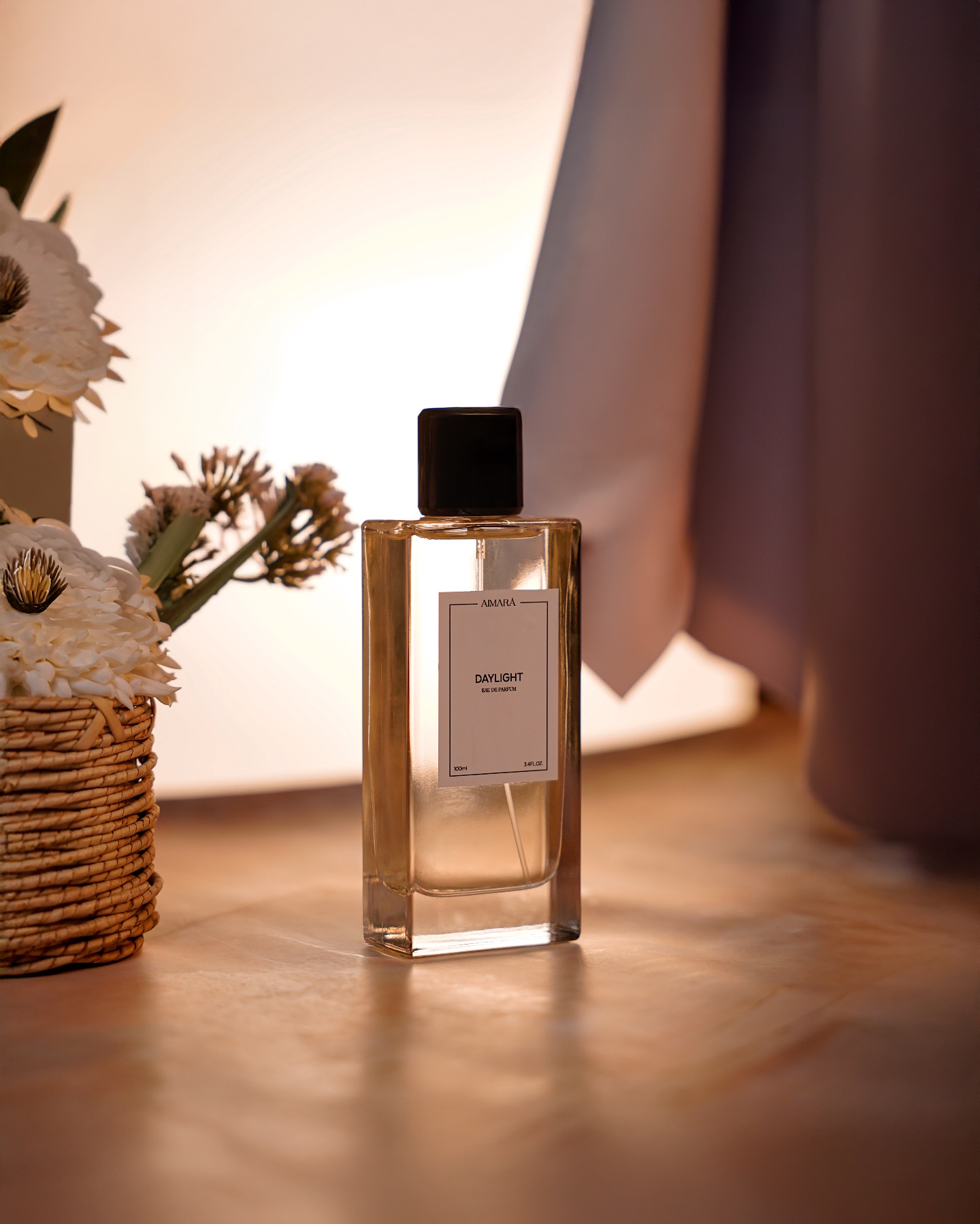 Luxury perfume bottle photographed in a warm indoor setting with soft lighting and floral styling.